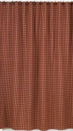 a red and white checkered curtain hanging on the side of a window sill