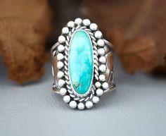 Chunky Blue Turquoise Sterling Silver Statement ring for women. This unique ring has been handmade using 925 Sterling Silver that has been fused, patina-ed then polished. The setting is a skinny oval Pilot Mountain Turquoise cabochon that is in a Bezel setting accented with twisted wire and beads. The stone is 21mm x 9mm and the tapered, wide band is 3/4" then narrows to1/8" for a comfortable fit. This ring cannot be resized, size 9.5. The holidays are right around the corner so shop early or you'll miss this one of a kind girlfriend gift or special surprise for mom, wife, sister or aunt.  Caring for your jewelry. Remove your Jewelry when pursuing outdoor sports and activities, including gardening and swimming, and when you are doing heavy house work. Avoid excessive impact against hard su Rings For Mom, Mom Rings, Girlfriend Ring, Pilot Mountain, Western Turquoise, House Work, Vero Beach Fl, Mom Ring, Unique Gifts For Mom