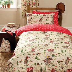 a bed covered in red and white christmas themed sheets