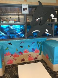 an aquarium themed booth with dolphins and other marine creatures