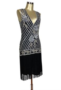 Exciting and romantic - our Artist Gown is the perfect dancing dress! A new take on the iconic fringe dresses of the 1920's, this gown will make you the star attraction at every event. Features include a handbeaded Deco rose design, deep vneck, and long silky fringe. So popular, the black and silver version of this gown was featured in the Academy Award winning film, "The Artist". Sheer, so a slip is recommended. XS....bust 30-34", waist 26-30", hips 34-38", length 49" S....bust 32-36", waist 28