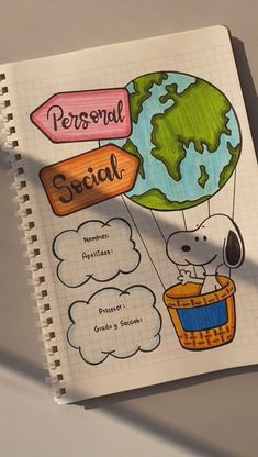 a notebook with an image of a person and a dog in a hot air balloon