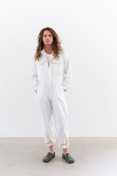 This vintage white coverall suit features covered zipper closure with snap at the waist and one at the chest, two flap chest pockets, two slant pockets, two back pockets, waist band. Hook and loop closure to adjust arm cuffs and leg cuffs. Maker: US Military |  Material: 100% cotton - super soft.  Condition: Great with a couple pin holes and a few small areas of discoloration on back right leg. Overall very bright white. MEDIUM: Shoulders: 17"  |  Chest: 22" (44" doubled)  |  Waist: 18" flat (36" doubled)  |  Hips: 21" at base of fly |  Front Rise: 14" to top of waist band  |  Inseam: 27.5" |  Length from shoulder to top of waistband: 17" |  Sleeve: 21.5" | Thigh: 13.75" | Leg Opening: 10" Elijah is 6'0". SHOP http://www.rawsonstudio.etsy.com FOLLOW US + instagram | @_rawson  + pinterest | White Overalls With Pockets, Vintage White Jumpsuits And Rompers For Spring, White Utility Overalls With Pockets, White Overall Jumpsuits And Rompers With Pockets, White Overalls Jumpsuit With Pockets, White Jumpsuits And Rompers With Pockets For Work, White Long Sleeve Jumpsuit With Pockets, White Overalls With Pockets For Workwear, Coveralls Mens