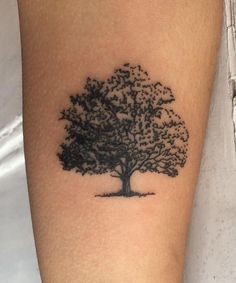 a small tree tattoo on the arm