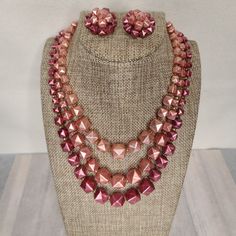 Vintage 1950s-1960s Three Strand Necklace And Clip On Earrings. Pyramid Studded Shaped In Shades Of Pink Pearl. Necklace Is 18" Inches In Length Including Extender. This Is A True Vintage Item. It Is Preowned And Not In New Or Unused Condition. Other Details: Please See Photos For All Details. All Items Come From A Smoke Free Home. Items Will Be Wrapped In White Tissue And Most Shipped In New Boxes, Their Original Box, Or Mailers But I Will Recycle When I Can. Packing Slips Will Not Be Included Retro Round Beads Jewelry For Party, Retro Round Bead Jewelry For Parties, Retro Beaded Jewelry For Party, Retro Beaded Evening Jewelry, Retro Beaded Jewelry For Evening, Retro Beaded Party Jewelry, Retro Evening Jewelry With Matching Earrings, Retro Matching Earrings For Evening Jewelry, Retro Matching Earrings For Evening