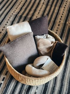 a basket filled with different types of pillows