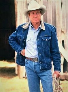 an older man wearing a cowboy hat and jeans