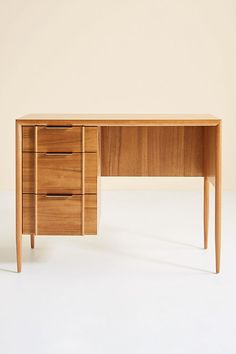 a wooden desk with three drawers on it