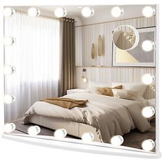 a bed sitting under a large mirror with lights on it's headboard and pillows