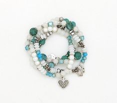 A turq, white, silver multi-strand bracelet or multi-layer bracelet of four separate pieces. This multi-strand wrap bracelet set is put together with tiny gemstones like beads and small assorted pendants (each piece is very similar, but not exact). #tlb #bohogift #bohemianfashion #BohemianBracelet #HippieBracelet White Multi-strand Jewelry With Silver Beads, White Multi-strand Bracelets For Jewelry Making, Silver Multi-strand Beaded Bracelets With Colorful Beads, Spiritual White Multi-strand Jewelry, Turquoise Multi-strand Handmade Bracelets, Bohemian Blue Multi-strand Beaded Bracelets, Bridesmaids Outfits, Turquoise Multi-strand Wrap Bracelet, Handmade Turquoise Multi-strand Beads