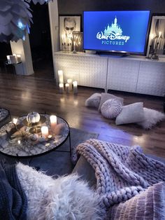 a living room filled with furniture and candles