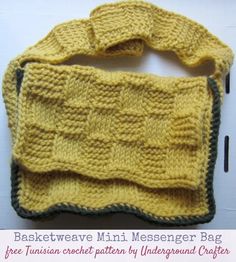 a yellow knitted bag sitting on top of a table