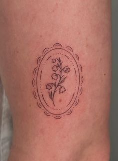 a small flower tattoo on the side of a woman's lower back ribcage