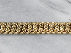 Polished and patterned links give this classic chain bracelet a feminine twist. The curb chain design allows this piece to lay comfortably on the wrist, and makes this bracelet perfect for layering with other pieces! Metal: 18K Yellow Gold Width: 14.0 mm Length: 8 Inches Marks: "750 CM 18K" Stamped on the clasp Luxury Bracelets With Chunky Cuban Link Chain, Formal Cuban Link Bracelet With Chunky Chain, Luxury Curb Chain Cuban Link Bracelet, Formal Cuban Link Chunky Chain Bracelet, Formal Chunky Cuban Link Bracelet, Luxury Curb Chain Link Bracelets, Yellow Gold Chunky Chain Link Bracelet, Luxury 14k Gold Curb Chain Bracelet, Classic Gold Cuban Link Chunky Chain Bracelet