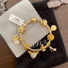 Linx Snake Chain Style Charm Bracelet With A Ball Clasp, Featuring Linx Logo. The Bracelet Comes With 9 Linx Charms As Shown. *All Items Are 14k Yellow Gold Over 925 Sterling Silver. *Linx Bracelets And Charms Are Very Well Made And Of Superior Quality, Designed To Last. These Pieces Come With A 100% Satisfaction Guarantee Or Your Money Back. *The Bracelet Is Available In Multiple Sizes *Additional Charms Can Also Be Added To The Bracelet And The Ones Included Are Removable As Well. *Linx Bracel Yellow Gold Bracelet With Charms, Linx Bracelets, Eyes Emoji, Gold Charms, Yellow Gold Bracelet, Girly Jewelry, Jewelry Companies, Bracelets And Charms, Gold Charm