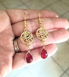 New Handmade Ruby Teardrop Dangle Earrings In each 14Kt yellow gold dangle earring, a pear-shaped Ruby is beautifully set in a bezel setting. These July birthstone earrings are the perfect accent for any occasion ~ Multi faceted stone captures light brilliantly  ~ Drop length measures 2 inches ~ Barrel cut Australian Crystal Ruby teardrop charms ~ Filigree circle charm ~ 14k gold over sterling silver ear hooks stamped .925 ~ Hypoallergenic  ☆I ship daily Monday-Saturday☆ Gift Packaging & Message Red Teardrop Chandelier Earrings As Gift, Red Chandelier Earrings As Gift, Red Nickel-free Chandelier Earrings As Gift, Red Elegant Nickel-free Teardrop Earrings, Red Nickel-free Teardrop Dangle Earrings, Nickel Free Elegant Red Chandelier Earrings, Red Teardrop Chandelier Earrings With Ear Wire, Red Teardrop Chandelier Earrings, Elegant Nickel-free Red Chandelier Earrings