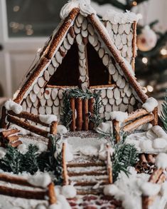 a close up of a gingerbread house with icing and cinnamons on it