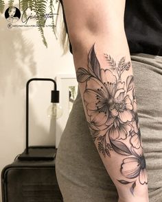 a woman with a flower tattoo on her arm