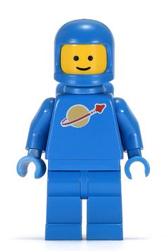 a lego man with a blue space suit and saturn sticker on it's chest