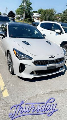 two white sports cars parked in a parking lot with the words saturday written on them