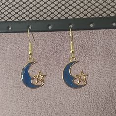 Blue Moon With A Gold Star On Nickel Free Gold Wires. New Without Tags Blue Crescent Moon Charm Earrings, Blue Moon-shaped Earrings With Moon Charm, Blue Moon Shaped Earrings With Moon Charm, Blue Moon Charm Earrings, Blue Crescent Earrings As A Gift, Blue Moon Shaped Celestial Earrings, Blue Celestial Moon Earrings, Celestial Blue Moon-shaped Earrings, Blue Moon-shaped Metal Jewelry