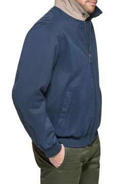 A solid colorway, golf bomber jacket with a small brand logo embroidery offers a sleek, layering appearance to any look. 26 1/2" length (size S) Front zip closure Spread collar Long sleeves Front welt pockets Shell: 84% polyester, 16% nylon; lining: 100% polyester; knit: 98% polyester, 2% spandex Machine wash, tumble dry Imported Model stats: 6'1" height, 32" waist. Model is wearing size S. Classic Long Sleeve Windbreaker, Classic Solid Windbreaker With Pockets, Classic Solid Color Windbreaker With Pockets, Casual Solid Track Jacket With Stand Collar, Stand Collar Windbreaker, Casual Solid Color Track Jacket With Zipper, Classic Windbreaker For Spring, Sporty Solid Outerwear With Ribbed Collar, Casual Solid Track Jacket With Double-lined Hood