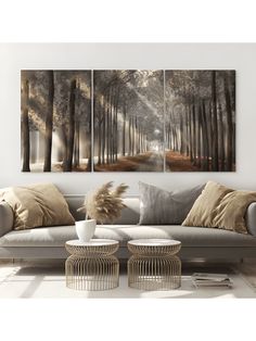 three paintings on the wall of a living room with couches and tables in front of them