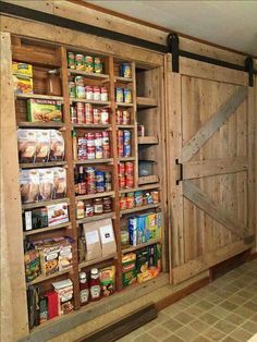 a wooden pantry with sliding doors on the side and shelves full of food in it