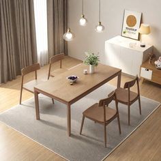 a dining room table and chairs in front of a window