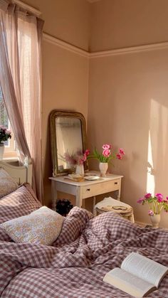 a bedroom with pink walls and plaid bedding