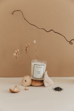 a candle and some garlic sitting on a table next to an object that looks like a plant