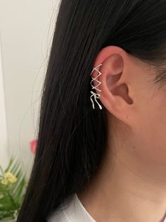 Unleash your daring side with Shoshana's ballet-core-inspired ear cuff! Featuring a lace-up design with a ribbon dangle and a mini pink cubic stone, this feminine yet edgy accessory will add a trendy touch to any outfit. Embrace the challenge and elevate your style with Shoshana.This ear cuff is meticulously crafted from nickel-free plated brass, ensuring both style and comfort. It's designed to be worn without a piercing hole-simply slide it onto your conch, snug, or helix area by gently opening the hoop. Please be mindful not to exert excessive force while adjusting to maintain the jewelry's shape and integrity.-Nickel-free plated brass-Type A: Short lace-up ear cuff with pink stone ribbon-Type A Earcuff: 13mm(dia)*9.6mm-Type A Ribbon: 15*22.5mm-Type B: Long lace-up ear cuff with an atta Side Piercing Ear, Earring Stacks Small Ears, Attached Earlobe Piercings, Ear Piercings Edgy, Feminine Piercings, Side Ear Piercing, Ribbon Piercing, Cute Ear Cuffs, Upper Helix Piercing