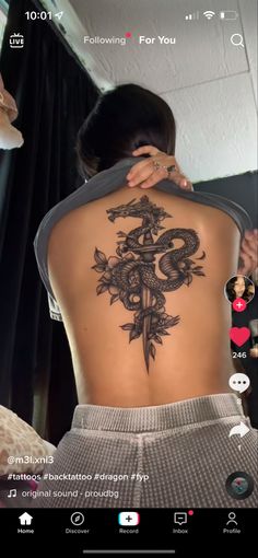 the back of a woman's body with an image of a dragon on it