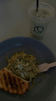 a plate with some food on it and a drink in the cup next to it