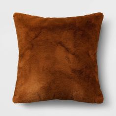 a brown pillow on a white background