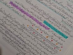 an open book with arabic writing on the pages and colored paper in different languages,