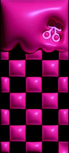 a pink object with scissors on it sitting on a black and white checkered surface