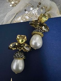 Prepare yourself for the festive season of 2022♥️ Stylish Pearl and Crystal Earrings. The material is brass with gold plating and stones  Weight: 18 grams a pair Prong Setting  Can go well with both Indian and Western wear. Gold Pierced Pearl Earrings For Party, Elegant Yellow Earrings For Party, Gold Costume Jewelry Earrings For Wedding, Gold Pearl Earrings For Festive Occasions, Gold Pearl Earrings For Party With Pierced Ears, Yellow Gold Plated Party Earrings, Gold Single Crystal Earring For Party, Gold Pearl Earrings For Celebration, Jeweled Teardrop Metal Earrings