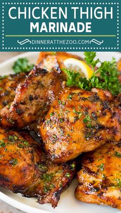 chicken thigh marinade on a plate with lemon wedges and parsley