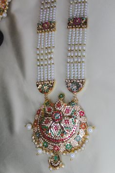 Discover the perfect piece of jewelry for your next special occasion with this exquisite gold-plated jadau ranihaar set. Add some sparkle to your look! NOTE: - It takes 11-25 working days minimum For Delivery. and sometimes it takes 3-4 weeks for delivery due to customs clearance and depending upon the location. We would always love to serve you. Thank you for shopping with us. Gold Plated Meenakari Jewelry For Puja, Yellow Gold Kundan Necklace With Meenakari For Puja, White Kundan Necklace For Puja And Eid, Meenakari 22k Gold Bridal Necklace For Puja, Traditional Gold Plated Bridal Necklace For Puja, White Kundan Jewelry Sets For Puja, Eid Jewelry With Zari Work For Puja, Zari Work Jewelry For Eid Puja, White Jewelry For Puja And Eid