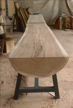 a piece of wood sitting on top of a metal stand in a room filled with wooden planks