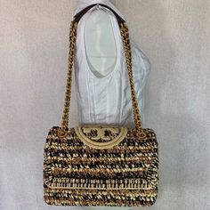 Brand New Never Been Carried. Soft Fleming Convertible Shoulder Bag By Tory Burch. This Bag Is Made Of Soft Raffia And Genuine Leather Trim Dimensions: 10.5" Wide X 7.5" Tall Center X 3.5" Deep. Doubled Chain Straps 12" Drop. Snap On Closure Interior: 1 Zipper Pocket And 1 Slip Pocket 2 Open And 1 Zipper Compartment Fabric Lining. Gold Tone Metalware. Luxury Handwoven Shoulder Bag, Designer Straw Bags With Intrecciato Weave, Designer Woven Straw Bag For Travel, Designer Woven Straw Travel Bag, Luxury Natural Straw Bag With Gold-tone Hardware, Designer Natural Straw Bag With Gold-tone Hardware, Designer Beige Handwoven Bag, Designer Handwoven Beige Bag, Designer Handwoven Travel Bags