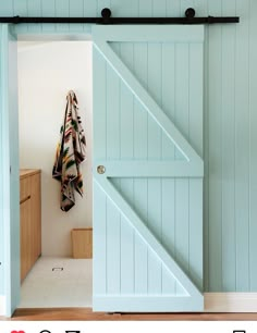 an open barn door with a towel hanging on it