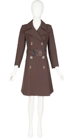 "This 1960s mod double-breasted brown wool coat is missing its designer label, but it's the same high quality that you would see from Cardin or other influential designers of the era. It has large pointed lapels, a pocket on each side, and a 22\" vent in the back. The belt has a large silver-tone metal buckle in the shape of an eye. It fastens with silver plastic round buttons, and has three matching decorative buttons on each cuffs. There are a few minor scratches on the belt buckle but the coat is otherwise in excellent condition, professionally dry-cleaned and ready to wear. Measurements: Bust - 32\" Waist - 29\" Hips - 34\" Shoulders - 14.5\" Sleeves - 20.5\" Length - 37\" IMPORTANT NOTE FOR CANADIAN SHOPPERS: There is a 15% shipping fee that is automatically applied to Canadian orders Formal Brown Wool Coat With Double Button, Fitted Brown Long Pea Coat, Designer Double-breasted Pea Coat For Office, Formal Brown Pea Coat With Double Button Closure, Brown Notch Lapel Pea Coat For Office, Brown Fitted Pea Coat For Workwear, Fitted Brown Pea Coat For Work, Brown Fitted Pea Coat For Work, Fitted Brown Wool Coat For Work