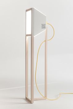 a light that is sitting on top of a table next to a white object with a yellow cord