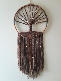 a wall hanging made out of wicker and beads