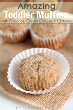 muffins in paper cups sitting on top of a table