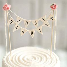 a white cake topped with a bunting banner