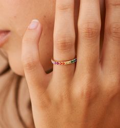 Meet our Rainbow Band Ring- this whimsical piece is adorned with an arc of meticulously selected CZ stones, each shimmering with the joyous hues of the rainbow. Perfect for the color-loving daydreamer, this ring is more than an accessory—it's your very own piece of wearable joy. Rainbow Stackable Jewelry For Promise Ring, Fine Jewelry Rainbow Rings For Gift, Unique Rainbow Rings For Gifts, Elegant Stackable Rainbow Ring, Rainbow 14k Gold Rings, Rainbow Band, Rainbow Ring, Rainbow Rings, Zodiac Necklaces