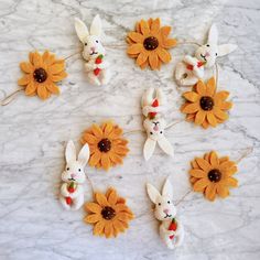 some bunny bunnies and sunflowers on a marble table with white marble background